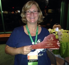 Elisabeth Wilkins posed with Virginia plaque represented the Volunteer of the Year Award.