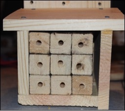 photo of artificial habitat for mason bees made from wood blocks