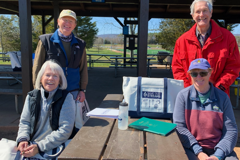 four volunteers posed at a picnic shelter