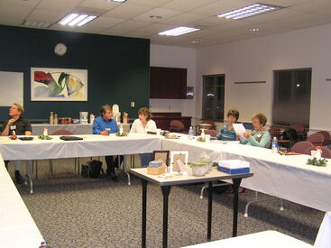 volunteers sitting at tables in a meeting room