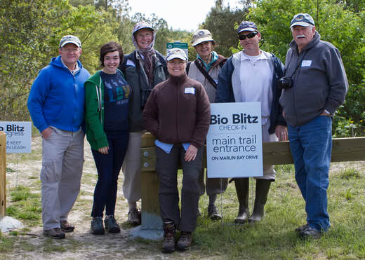 Photo of 7 people next to a BioBlitz check-in sign