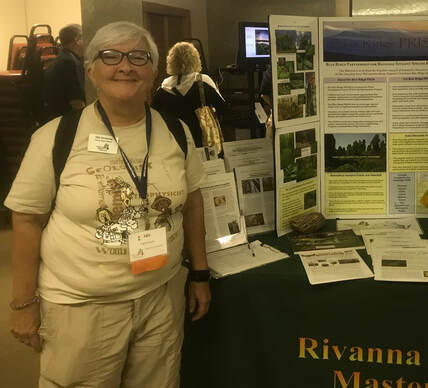 woman in Virginia Master Naturalist nametag next to table with nature publications