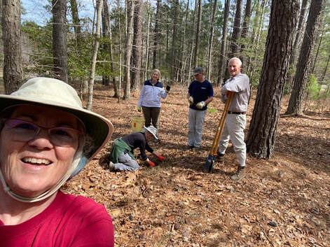 selfie of group of people planting a tree