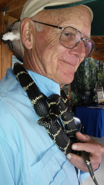 Image of Lee Hesler holding a king snake