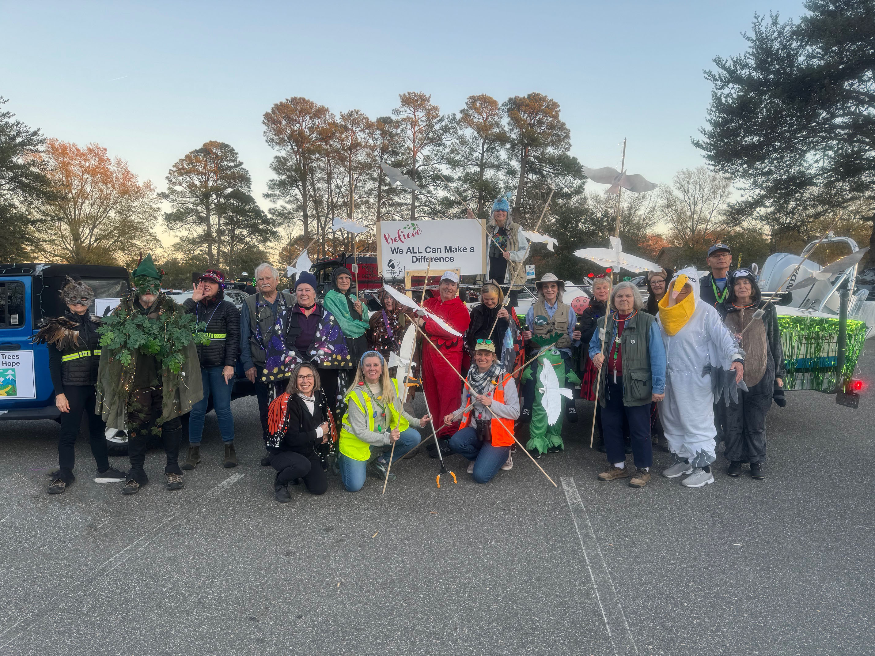 group of people in costumes and holding bird puppets