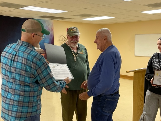 volunteer receiving an award certificate