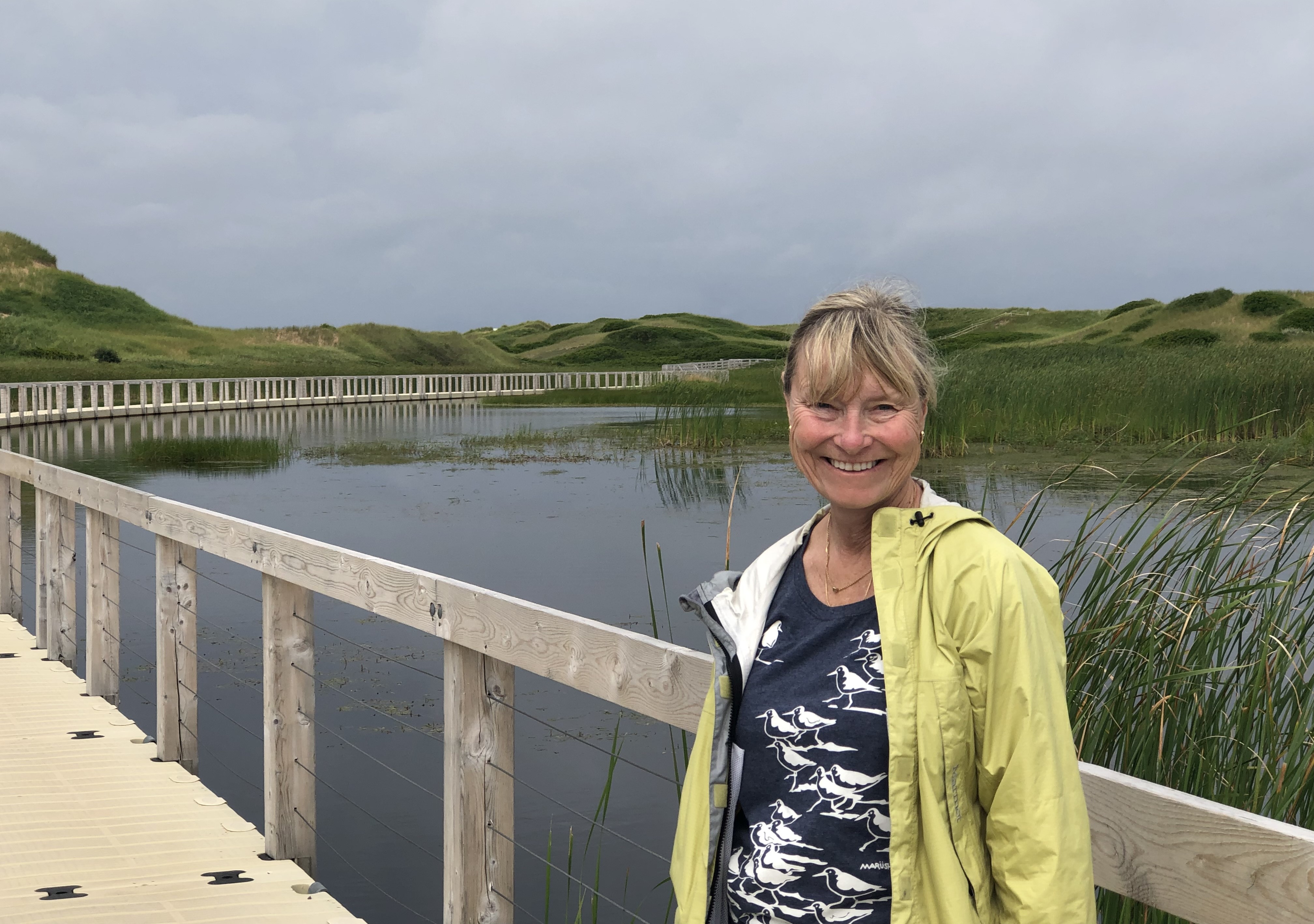 volunteer posed by a marsh