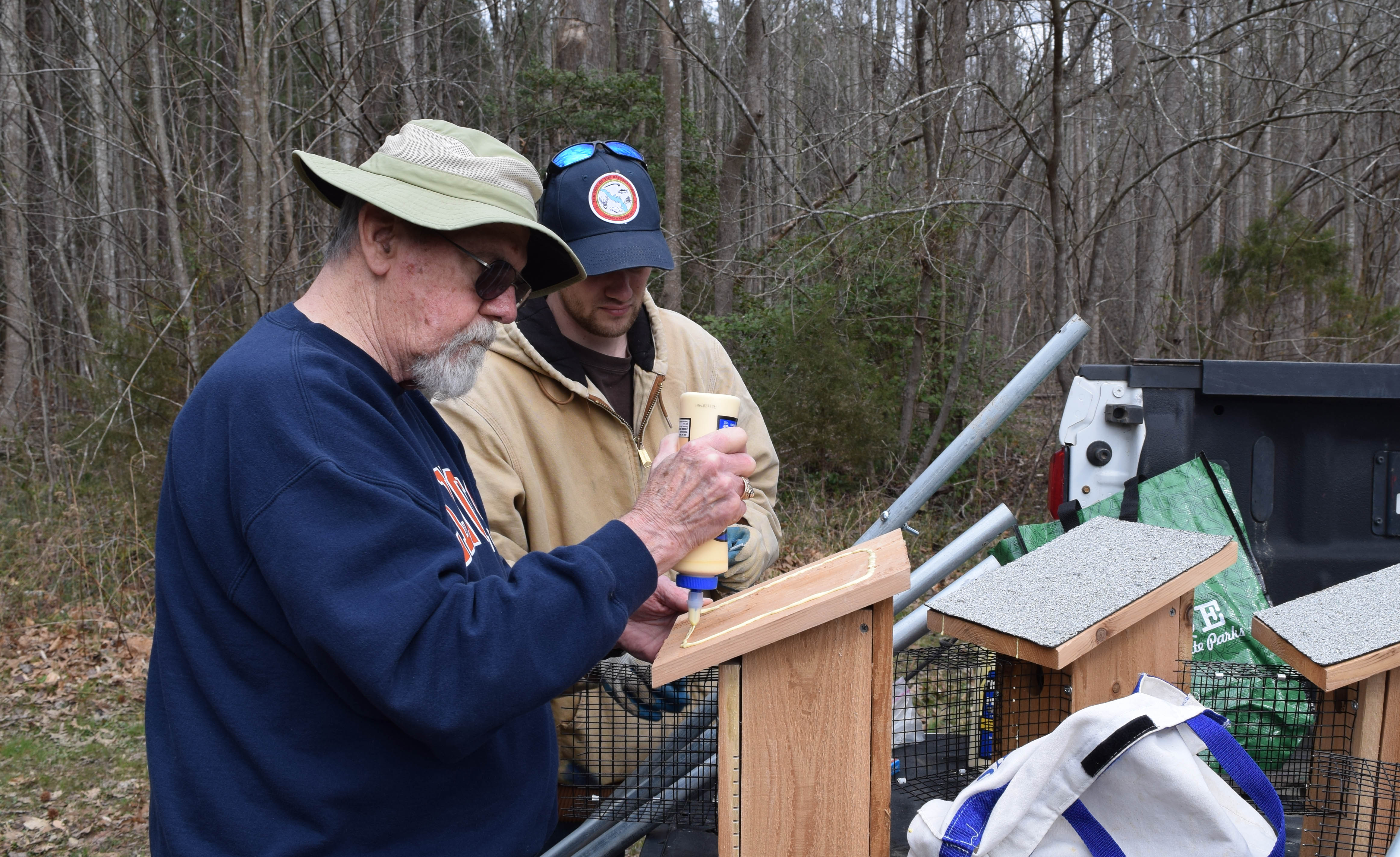 two people building a bluebird nest box