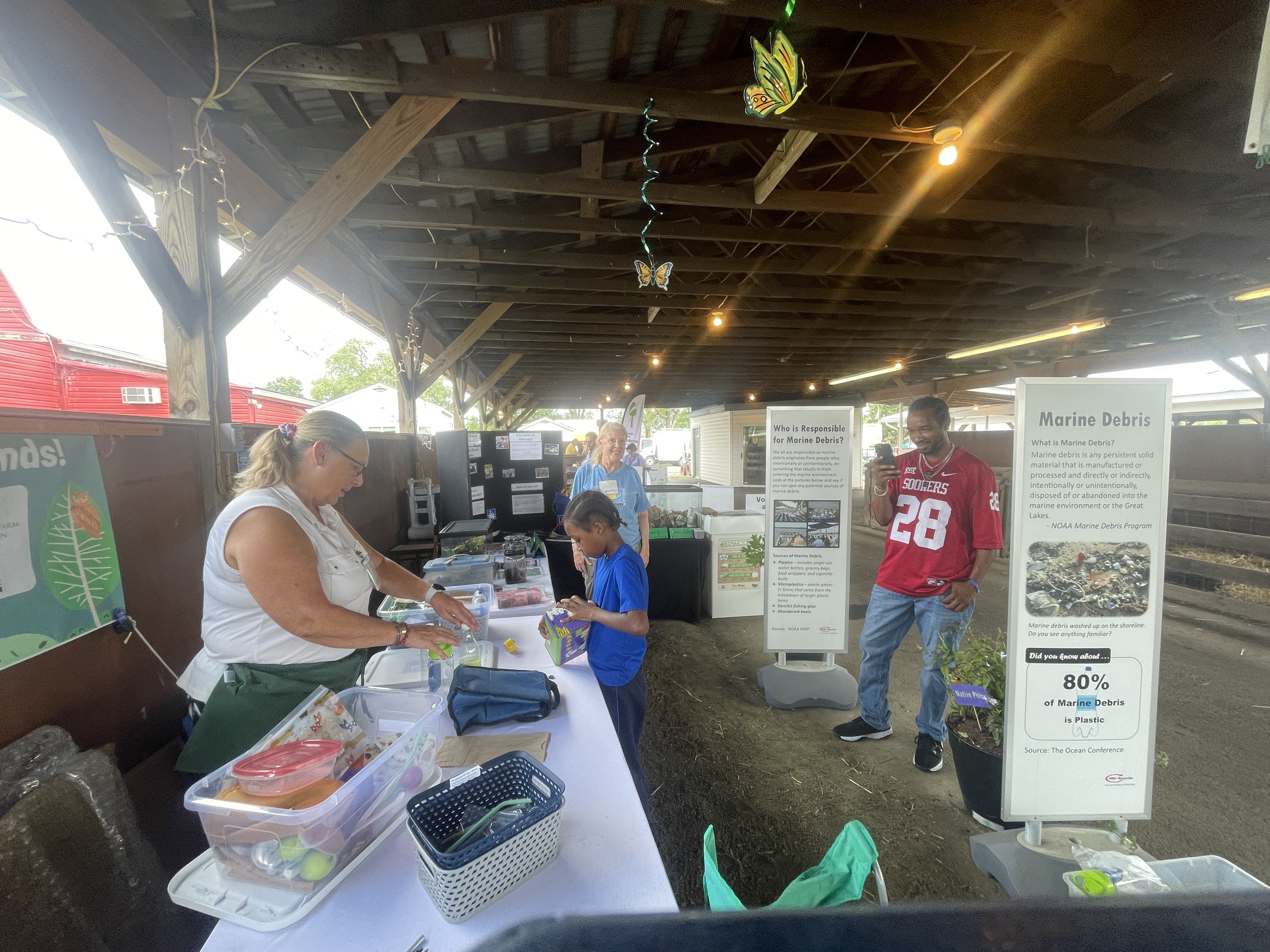 volunteer showing nature objects to youth and adult