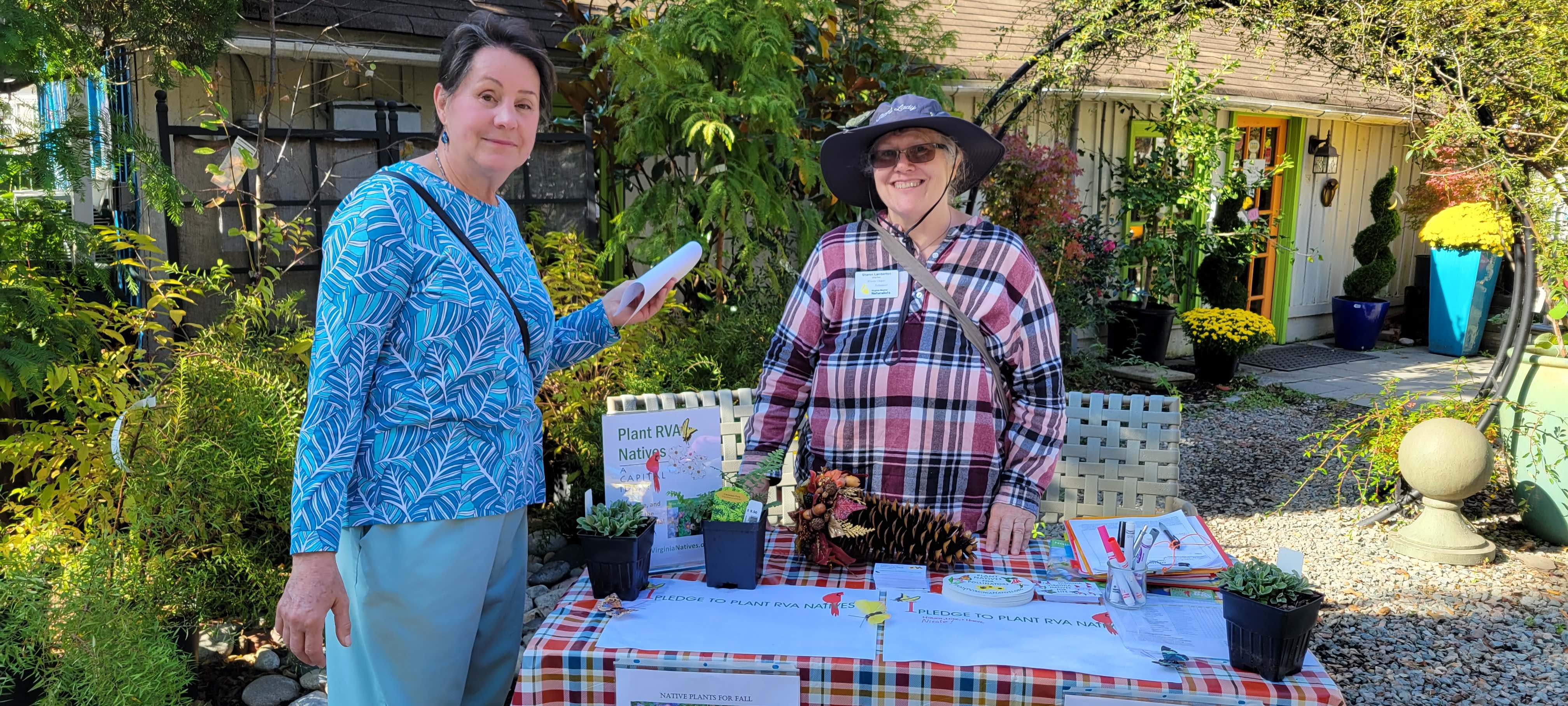 volunteers at a table outside a garden nursery