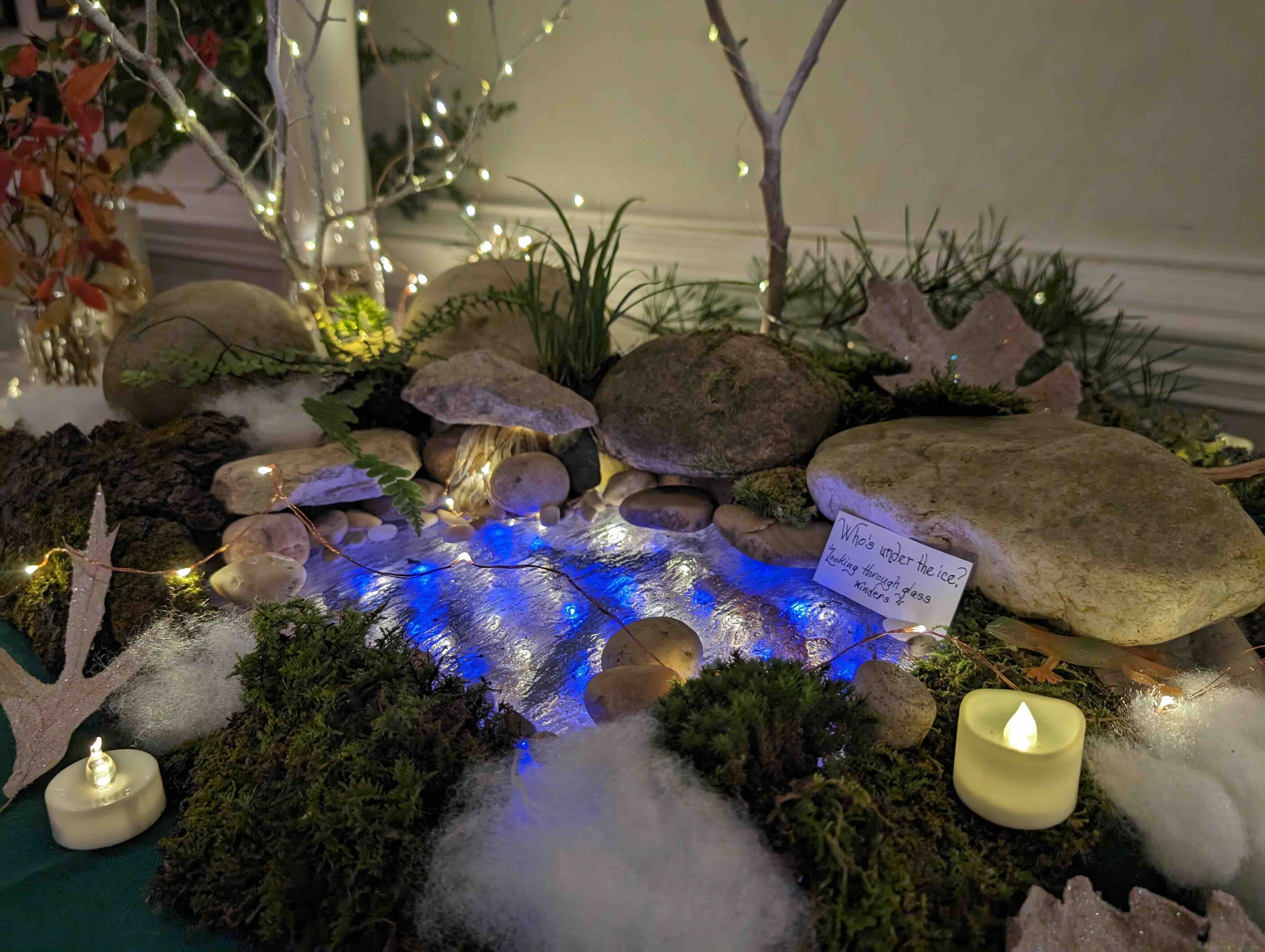 display on a table with rocks, lights, and candles