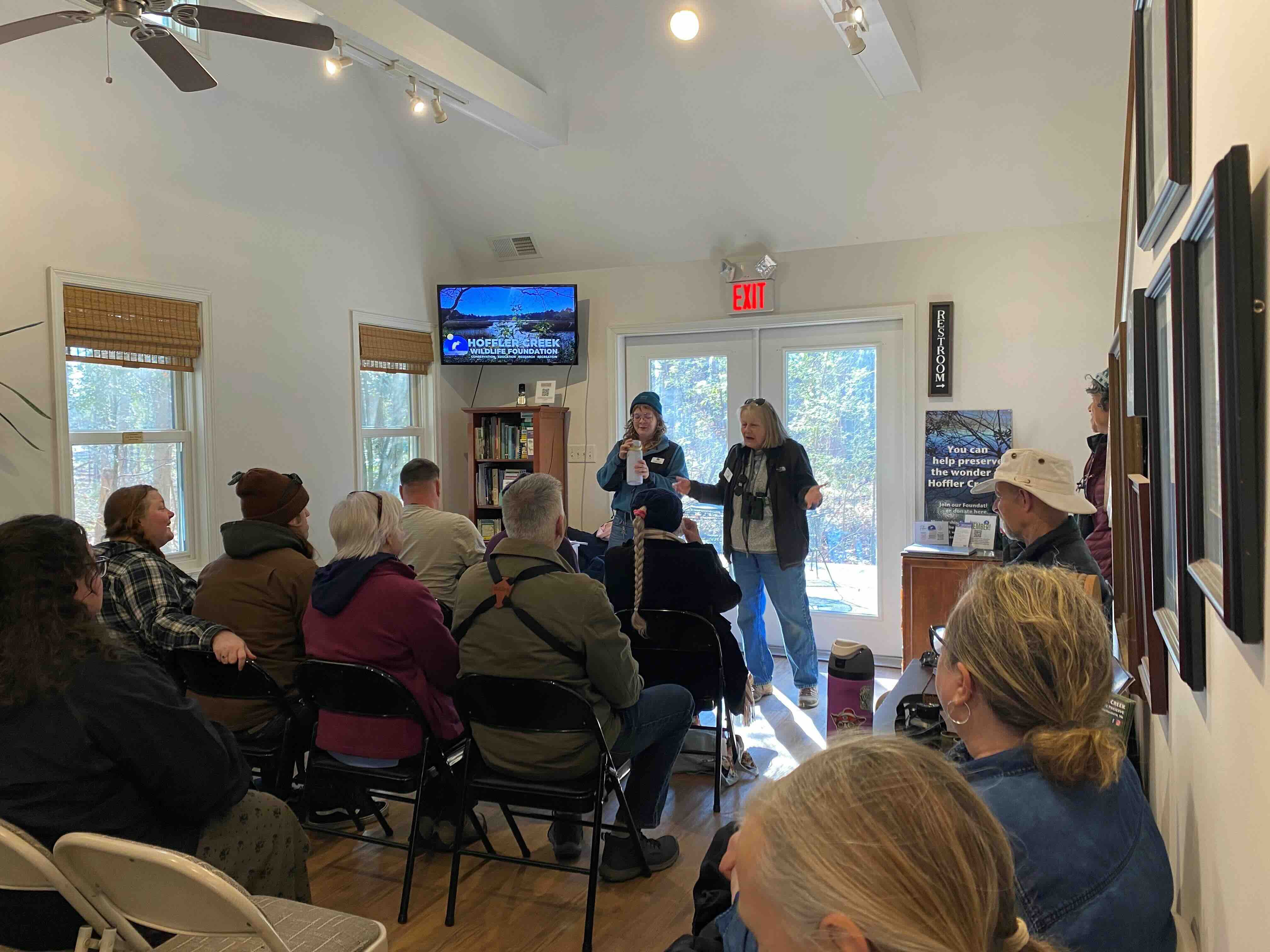 People seated in a room watching a presenter talk about Hoffler Creek